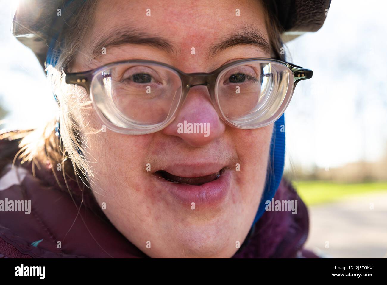 Outdoor portrait of a 39 year old white woman with the Down Syndrome