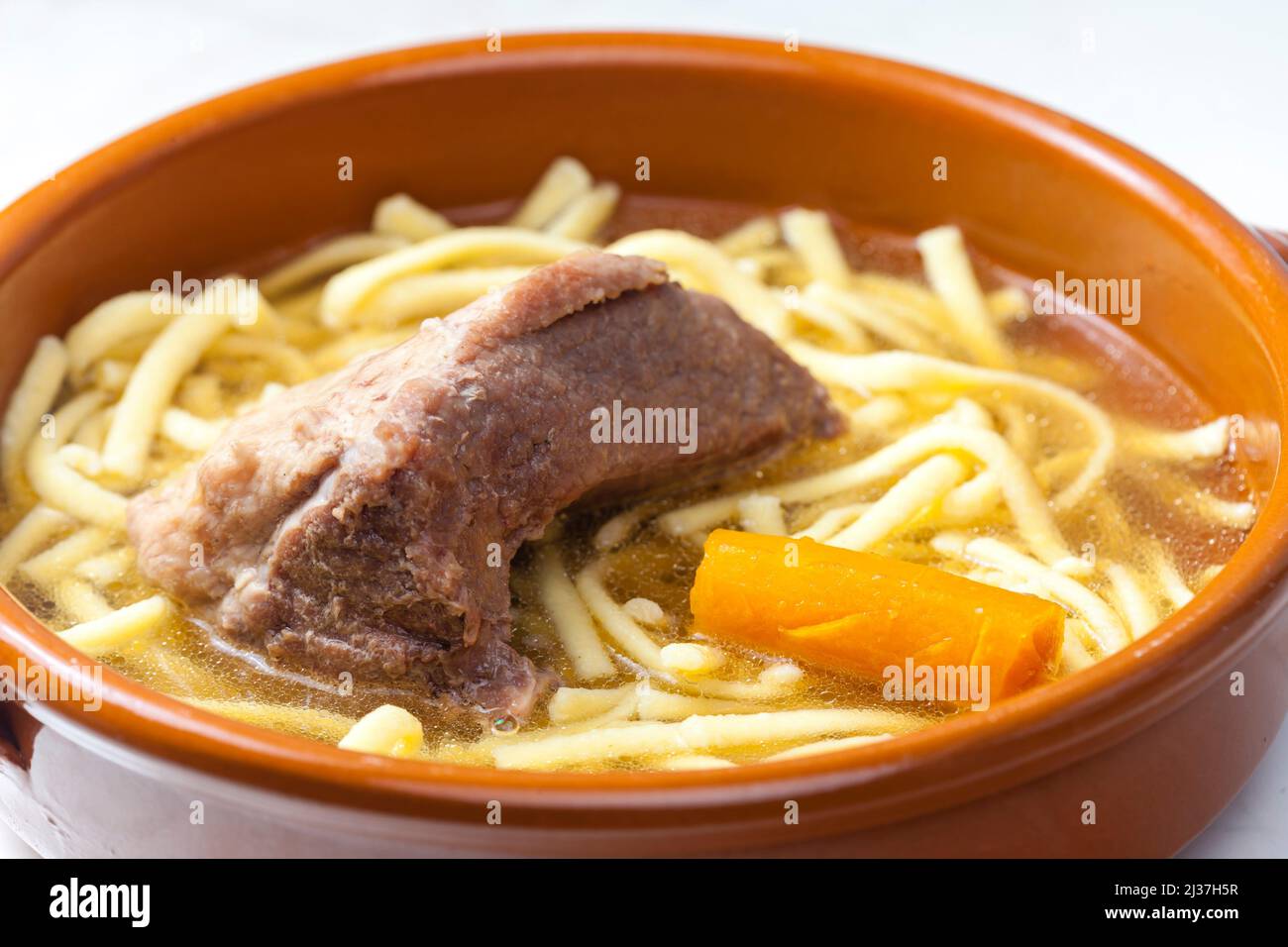 beef bouillon with carrot and noodles Stock Photo Alamy