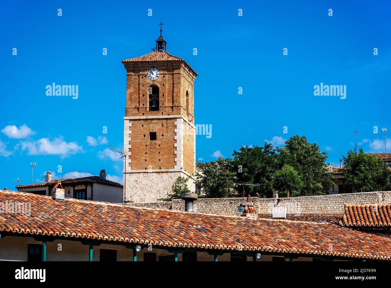 View of Clock Tower of Chinchon in Madrid. Low angle view agaisnt sky. Old Our Lady of Grace church. Stock Photo