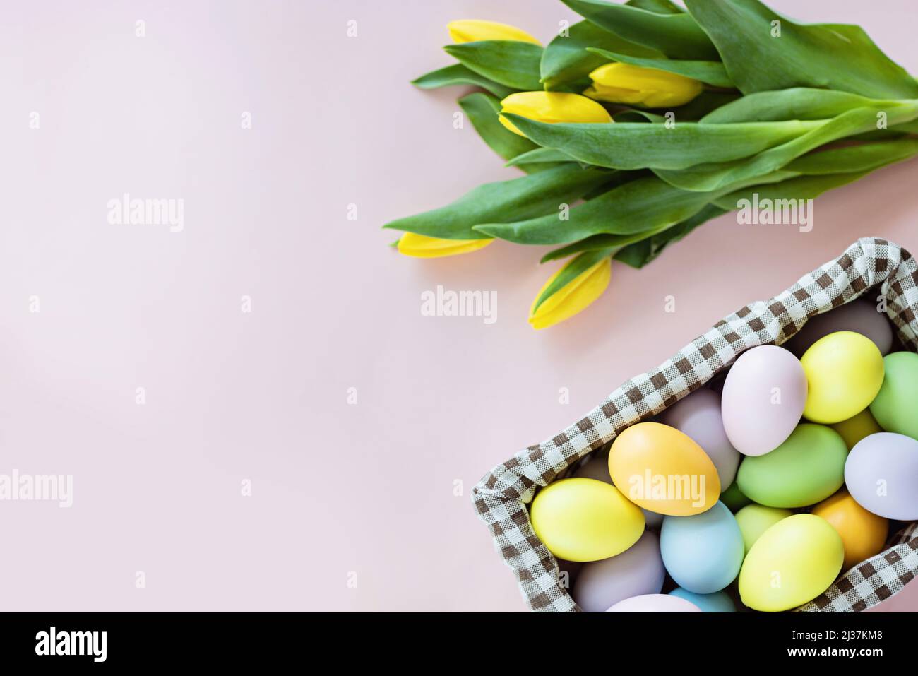 Stylish background with colorful easter eggs isolated on pastel pink ...