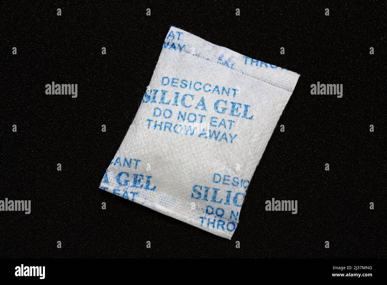 Silica gel in a package on black background. Silica gel used to protect