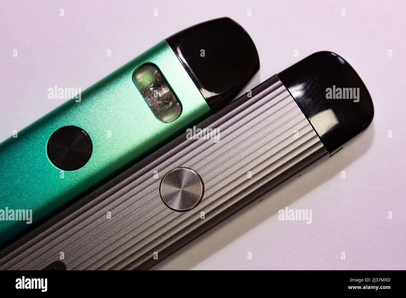 Nicotine vapor sticks top view. Green and gray electronic cigarettes on isolated white background. Stock Photo