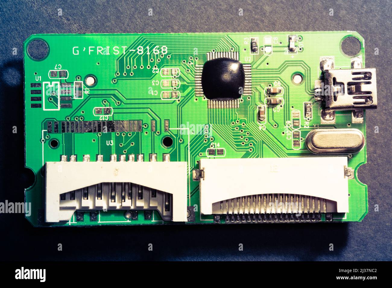 Top view of PCB board of a CF, micro SD and SD card reader. Electronic circuit elements and connection inputs on the main board. Stock Photo