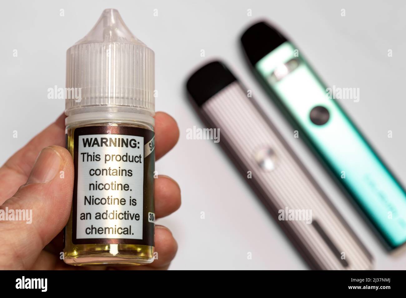 Electronic cigarette liquid selective focus. On the plastic bottle it