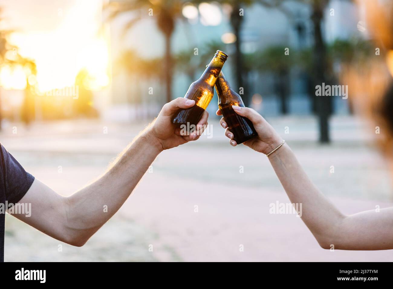 Two young people celebrating with beers Stock Photo