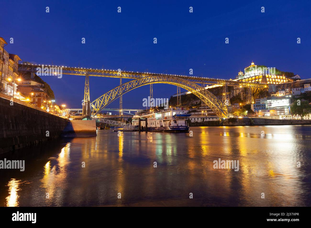 Europe, Portugal, Porto, Ribeira District; Looking across the Douro River at Night towards the Vila Nova de Gaia and Luís I Bridge. Stock Photo