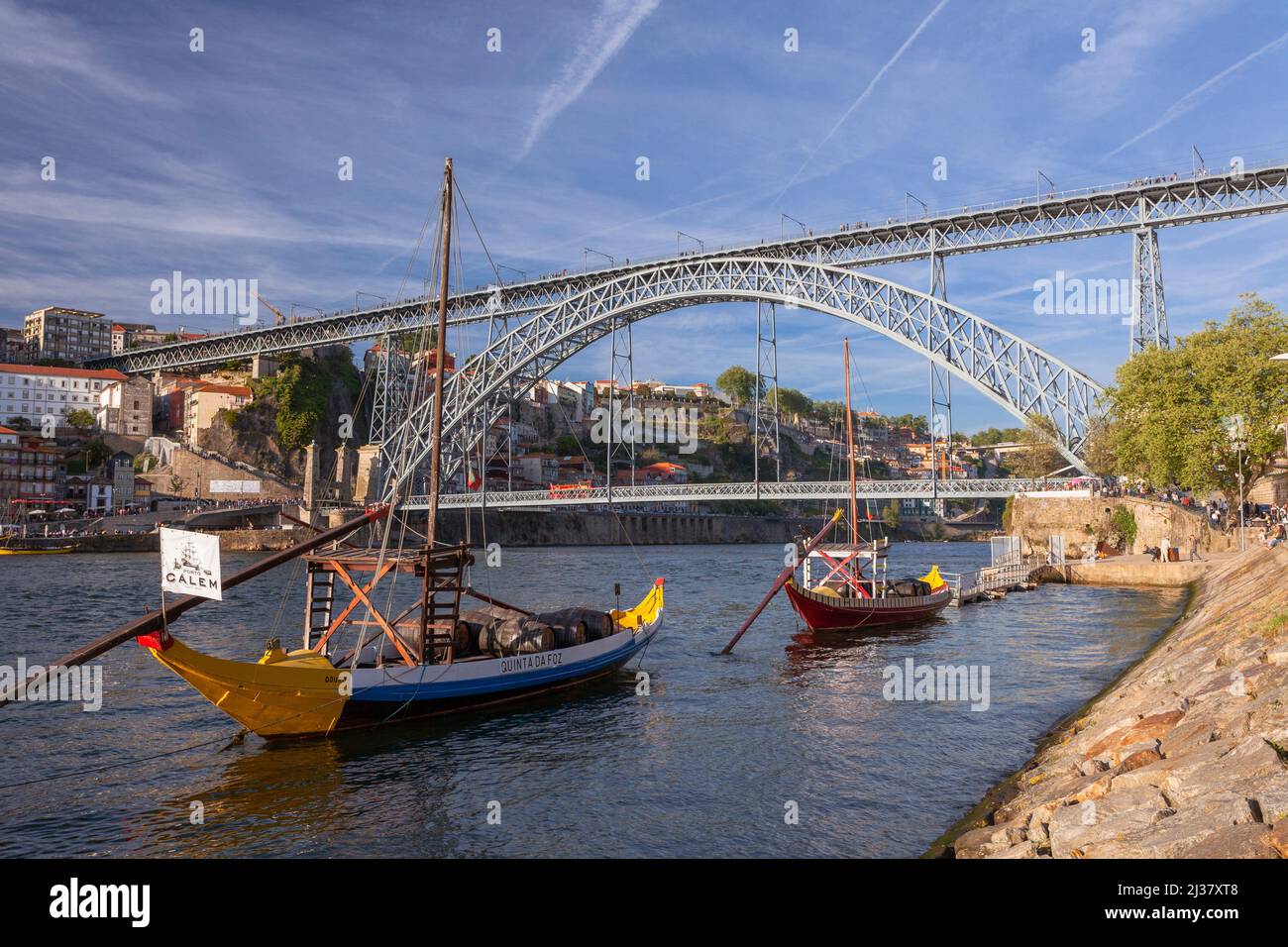 Europe, Portugal, Porto, Vila Nova de Gaia, Luís I Bridge (Ponte Luís I) across the Douro River with Traditional Wooden Boats. Stock Photo