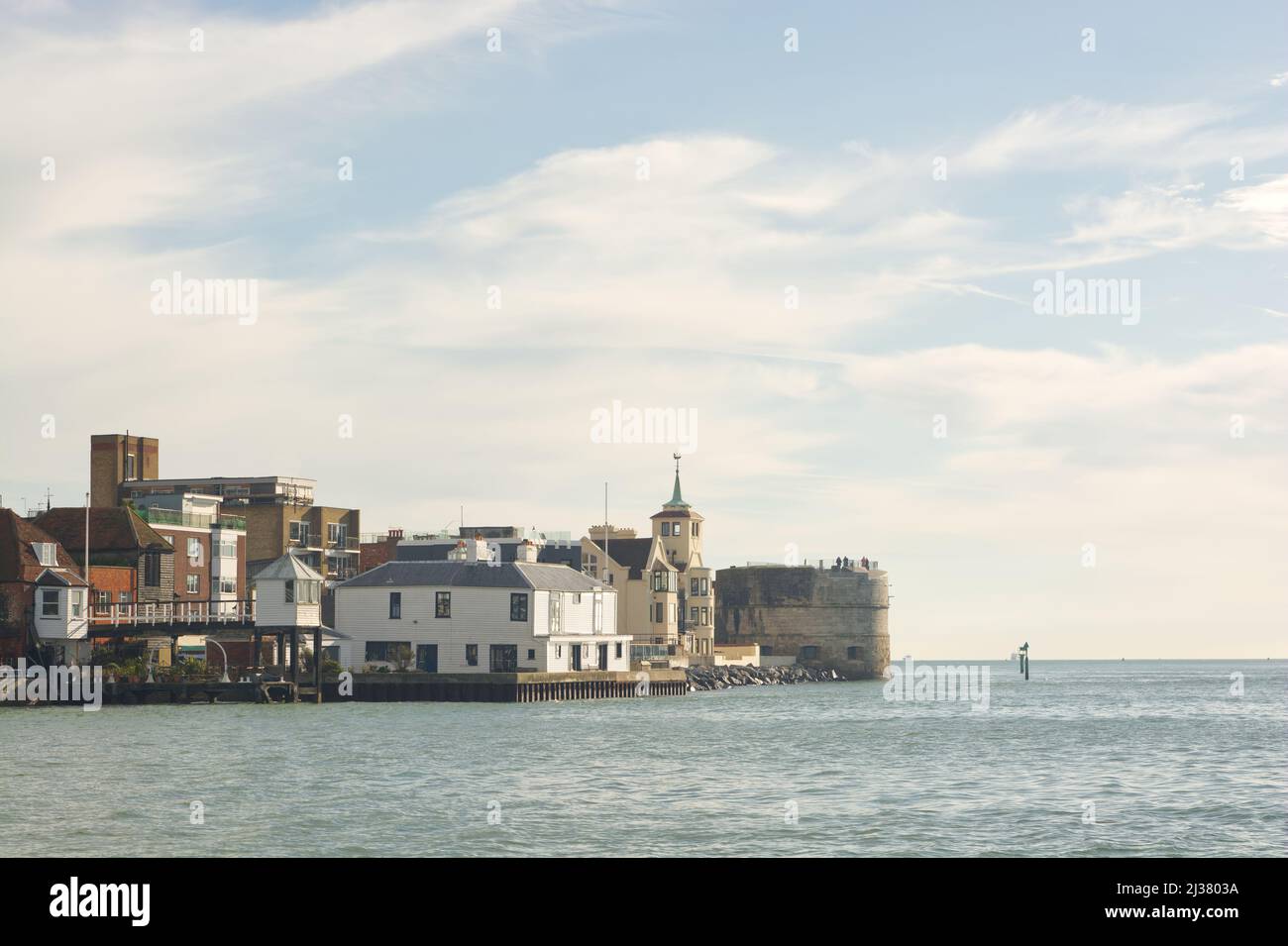 Houses and buildings at the entrance to harbour, Portsmouth, Hampshire, England. Viewed from boat on the water. Stock Photo