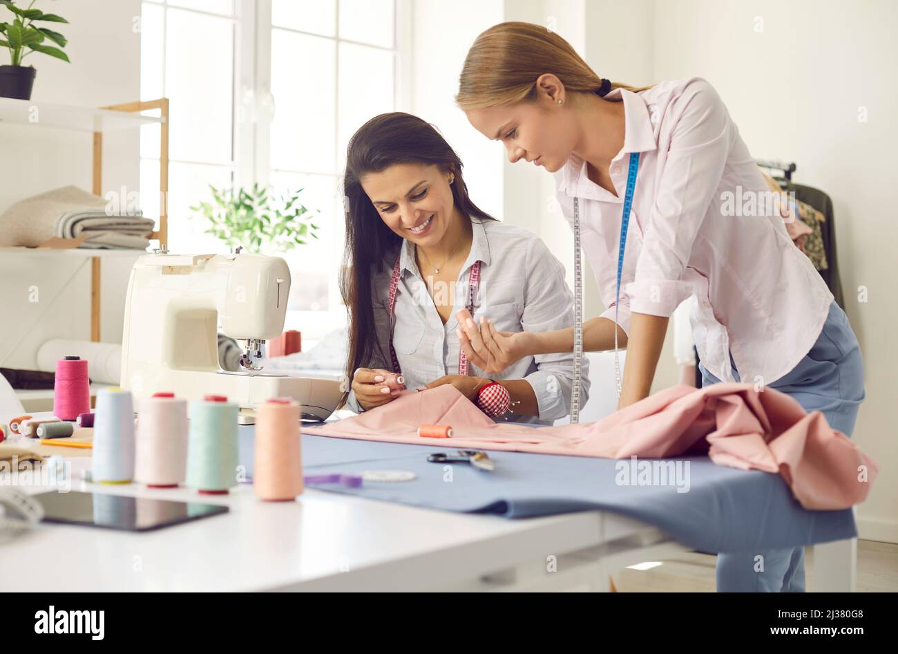 Female tailors work together in fashion atelier Stock Photo Alamy