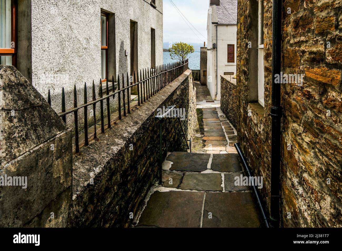 Alley leading to a vista of the sea. Stromness. Orkney Islands