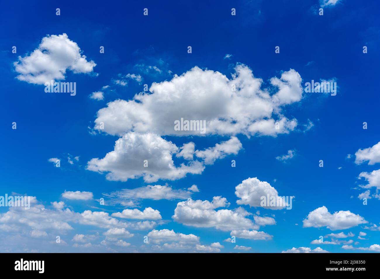 Blue sky background with white cumulus clouds floating Stock Photo - Alamy