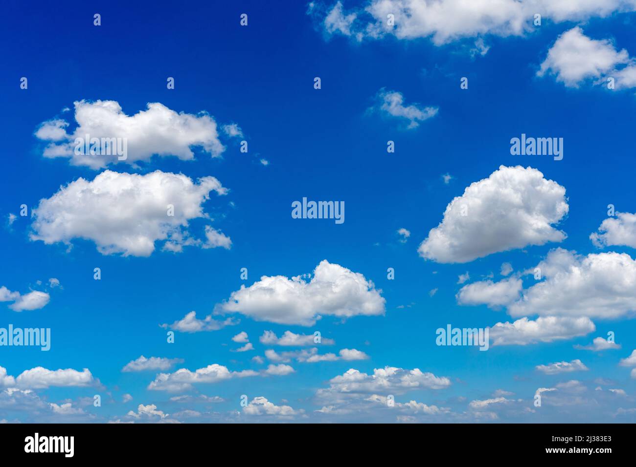 White cumulus clouds floating in the blue sky Stock Photo