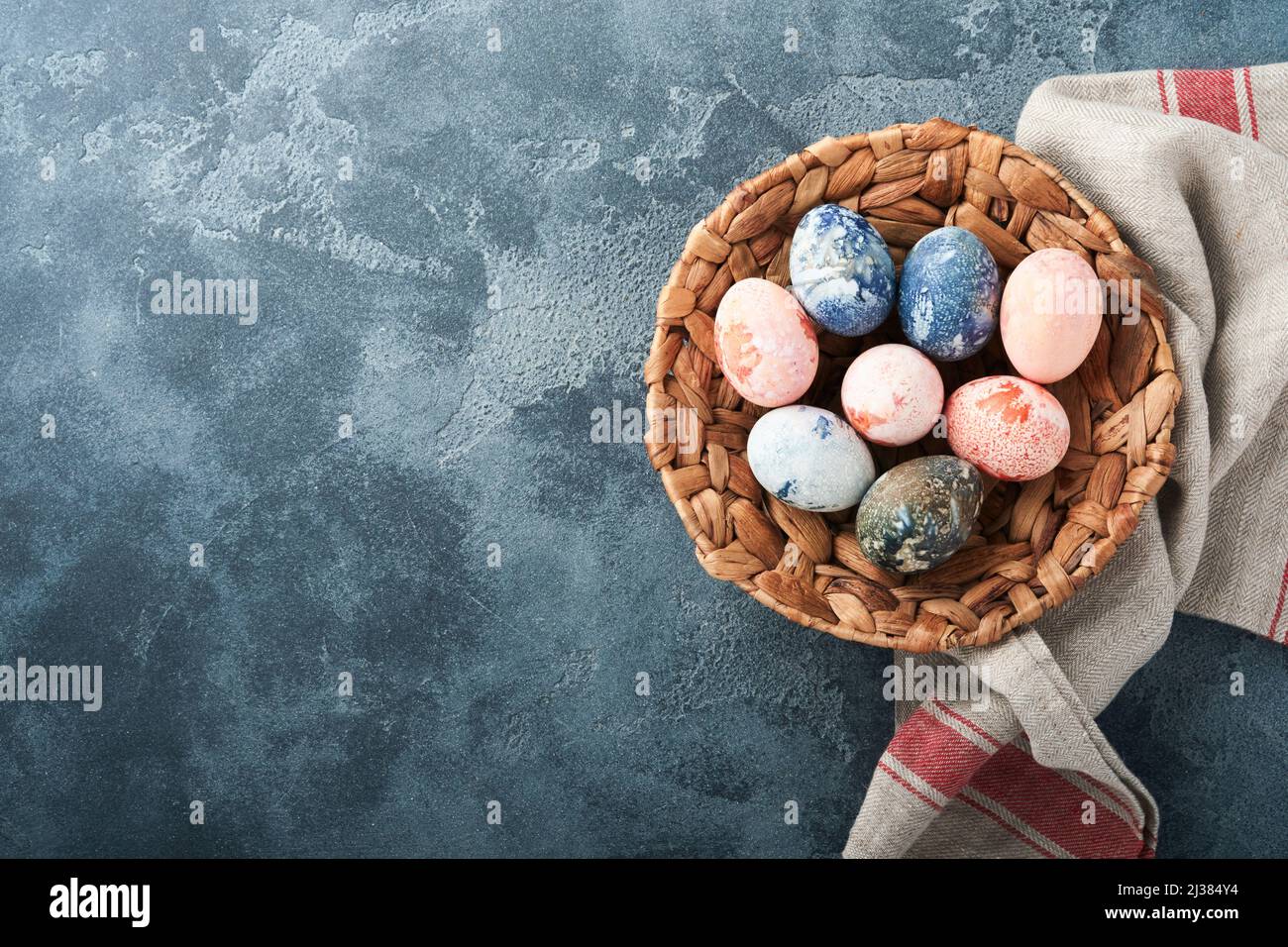 Easter eggs. Dyed Easter eggs with marble stone effect ref and blue color in rustic style on dark stone background. Easter background. Top view. Stock Photo