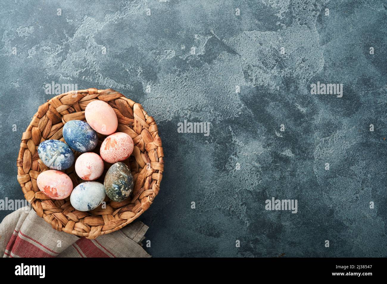 Easter eggs. Dyed Easter eggs with marble stone effect ref and blue color in rustic style on dark stone background. Easter background. Top view. Stock Photo