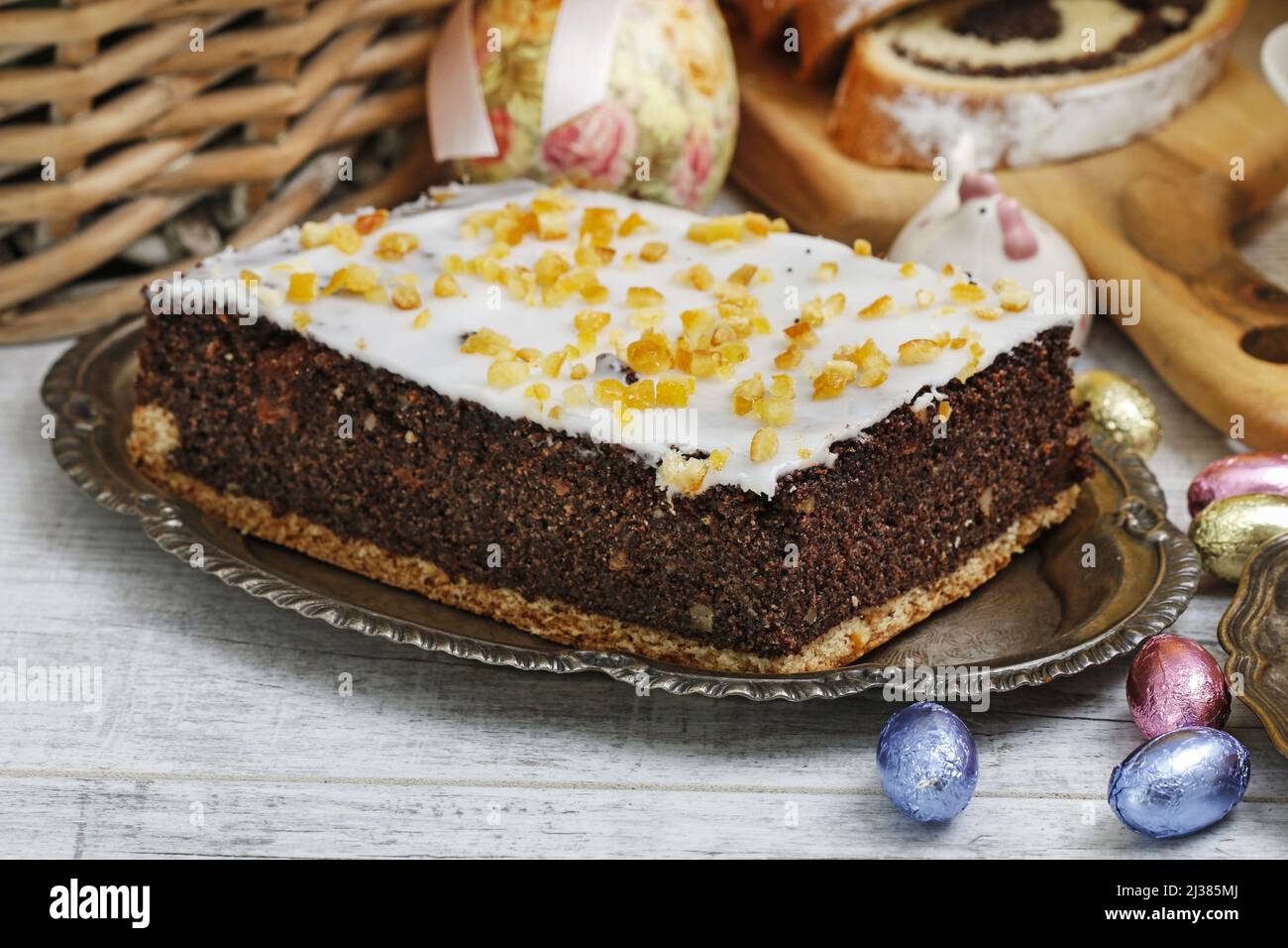 Poppy seed cake with icing coating decorated with orange peel. Festive