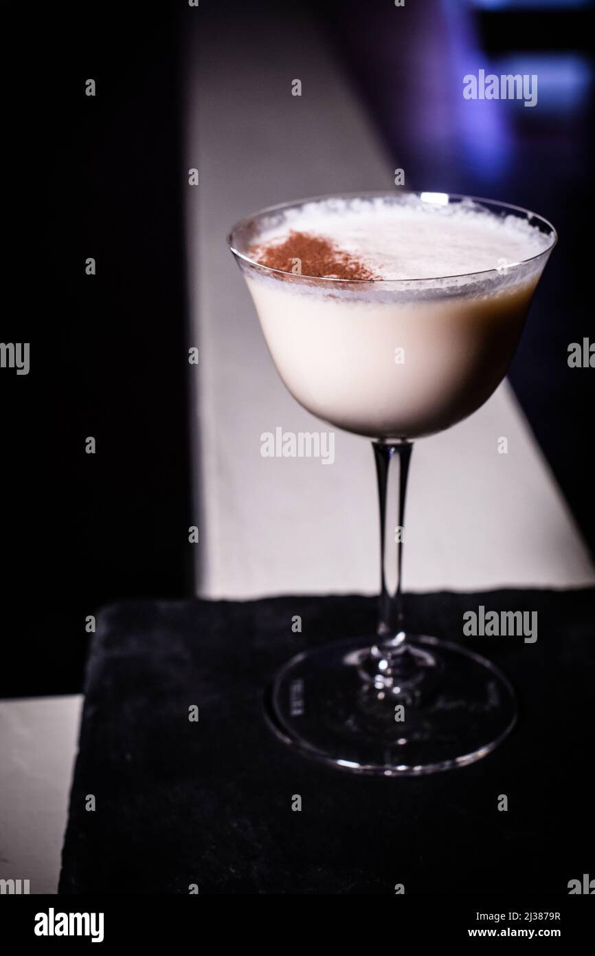 A classic Alexander brandy cocktail with fresh nutmeg on top in a glass