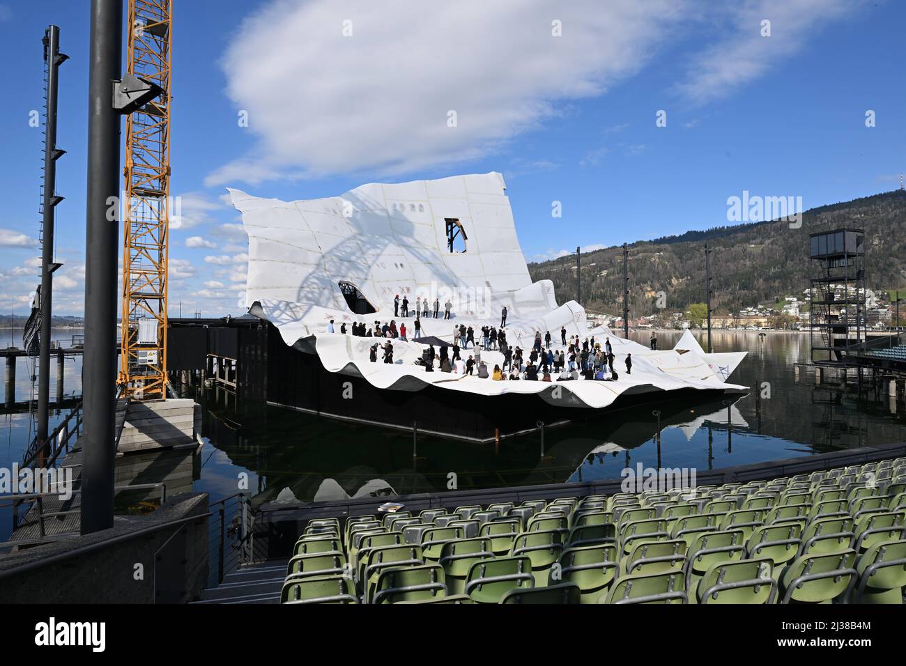 Bregenz, Austria. 06th Apr, 2022. Dozens of journalists, craftsmen and  employees of the Bregenz Festival stand at the topping-out ceremony on the  lake stage, where preparations for the opera Madame Butterfly by