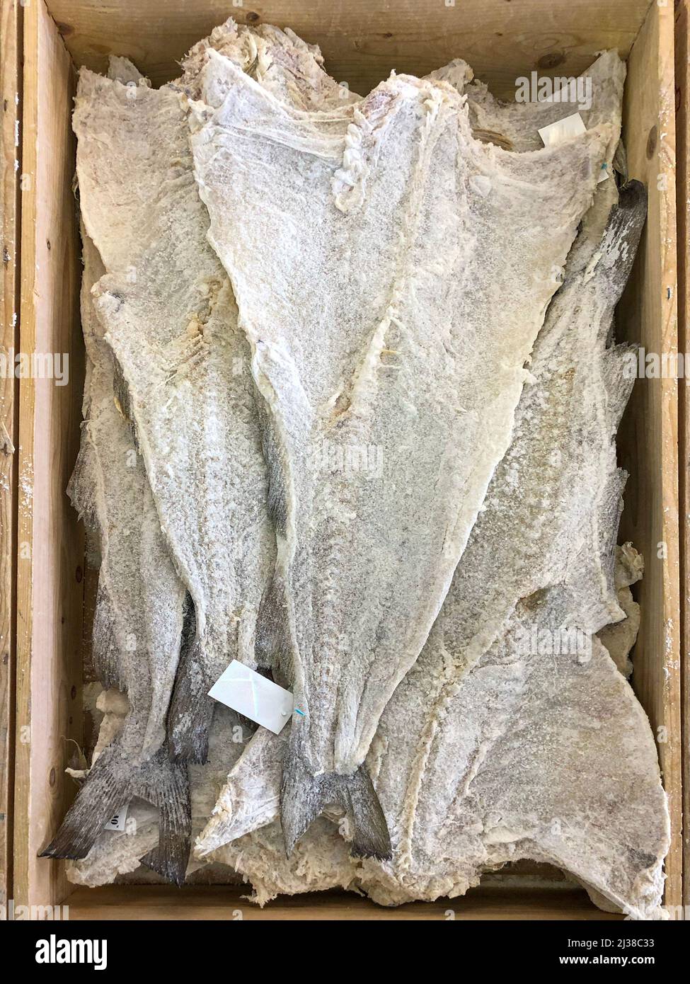 Raw salted cod, whole in the box Stock Photo Alamy