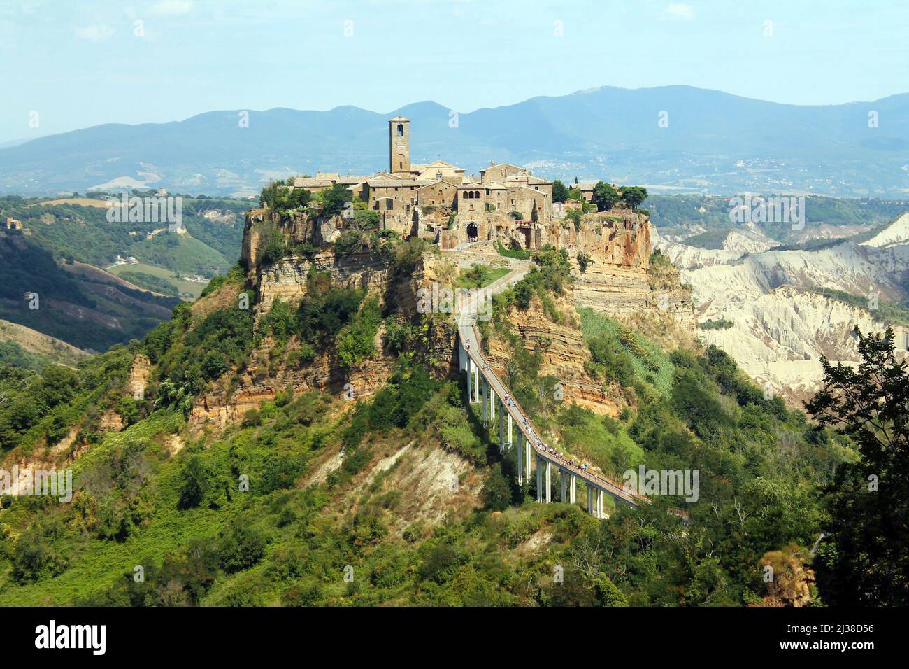 Close up of the historical civita village of Bagnoregio standing on a cliff with the long pedestrian bridge in the center of Italy Stock Photo