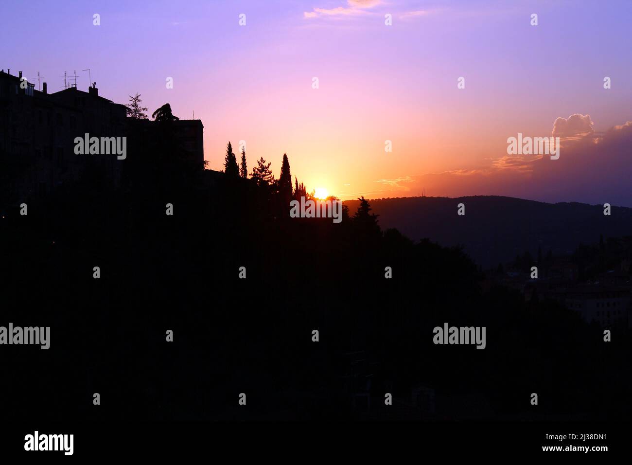 A purple sunset on the hills of Umbria from Perugia in Italy Stock Photo