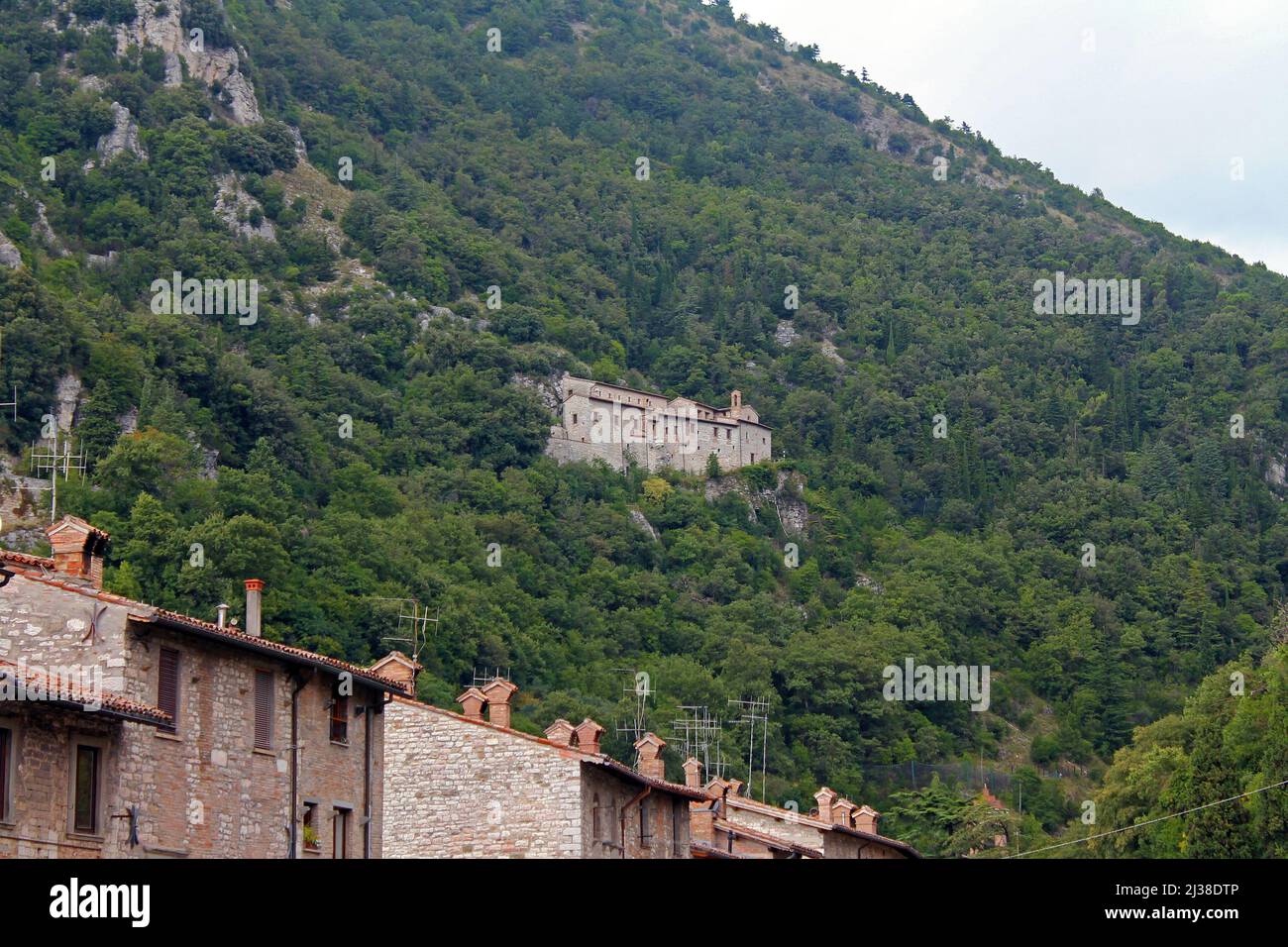 The traditional village on the cliff among the trees in Umbria in Italy Stock Photo