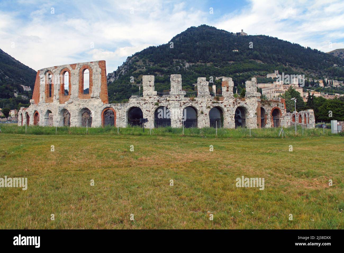 The historic arena in the center of Gubbio with the grass around in Umbria in Italy Stock Photo