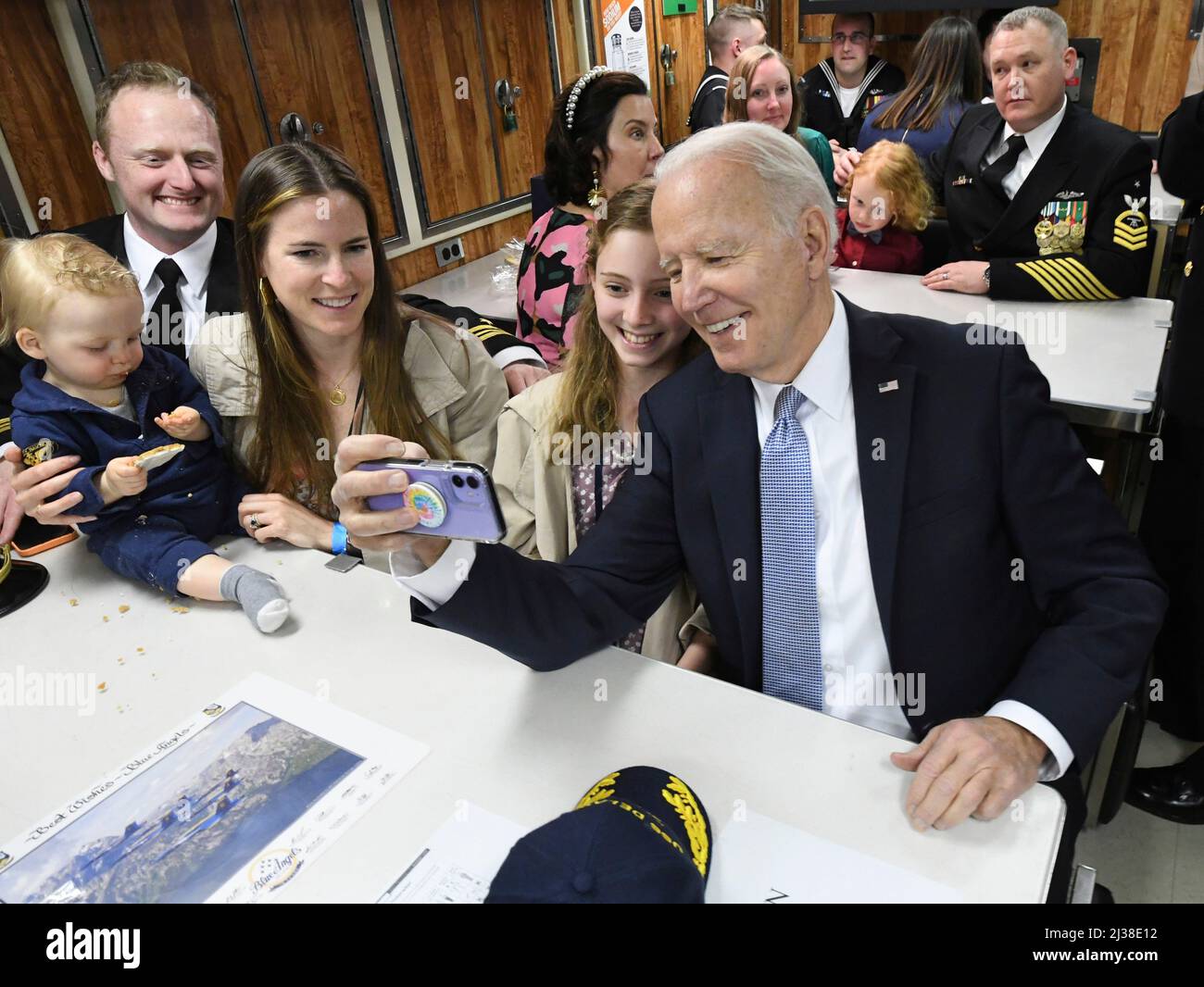 Wilmington, United States of America. 02 April, 2022. U.S President Joe Biden, takes a selfie with Lt. Cmdr. Adam Parkinson and his family on board the Virginia-class submarine USS Delaware following the commissioning ceremony, April 2, 2022 in Wilmington, Delaware.  Credit: CPO Joshua Karsten/US Navy/Alamy Live News Stock Photo