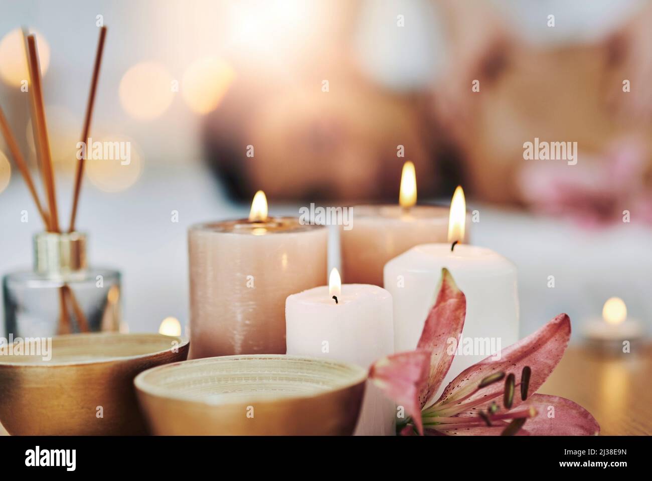 Candles to set some ambiance. Shot of a relaxed an cheerful young woman
