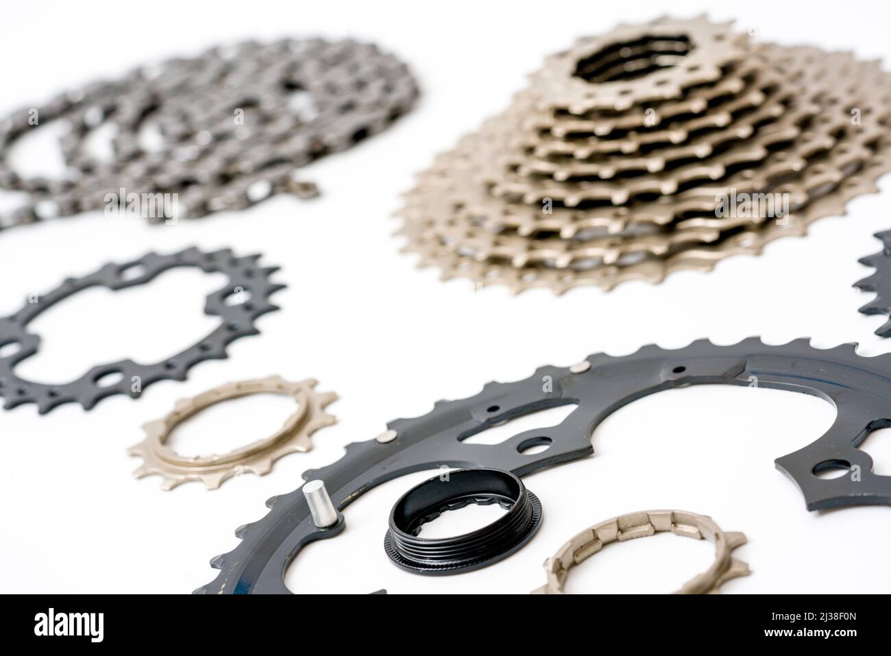 Gears, sprockets and chain of a mountain sports bike on a white