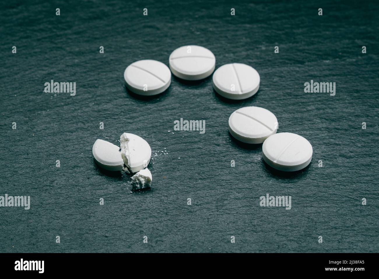 MDMA Pill known as ecstasy  E  or molly, is a psychoactive drug primarily used for recreational purposes. MDMA drugs  on black background Stock Photo