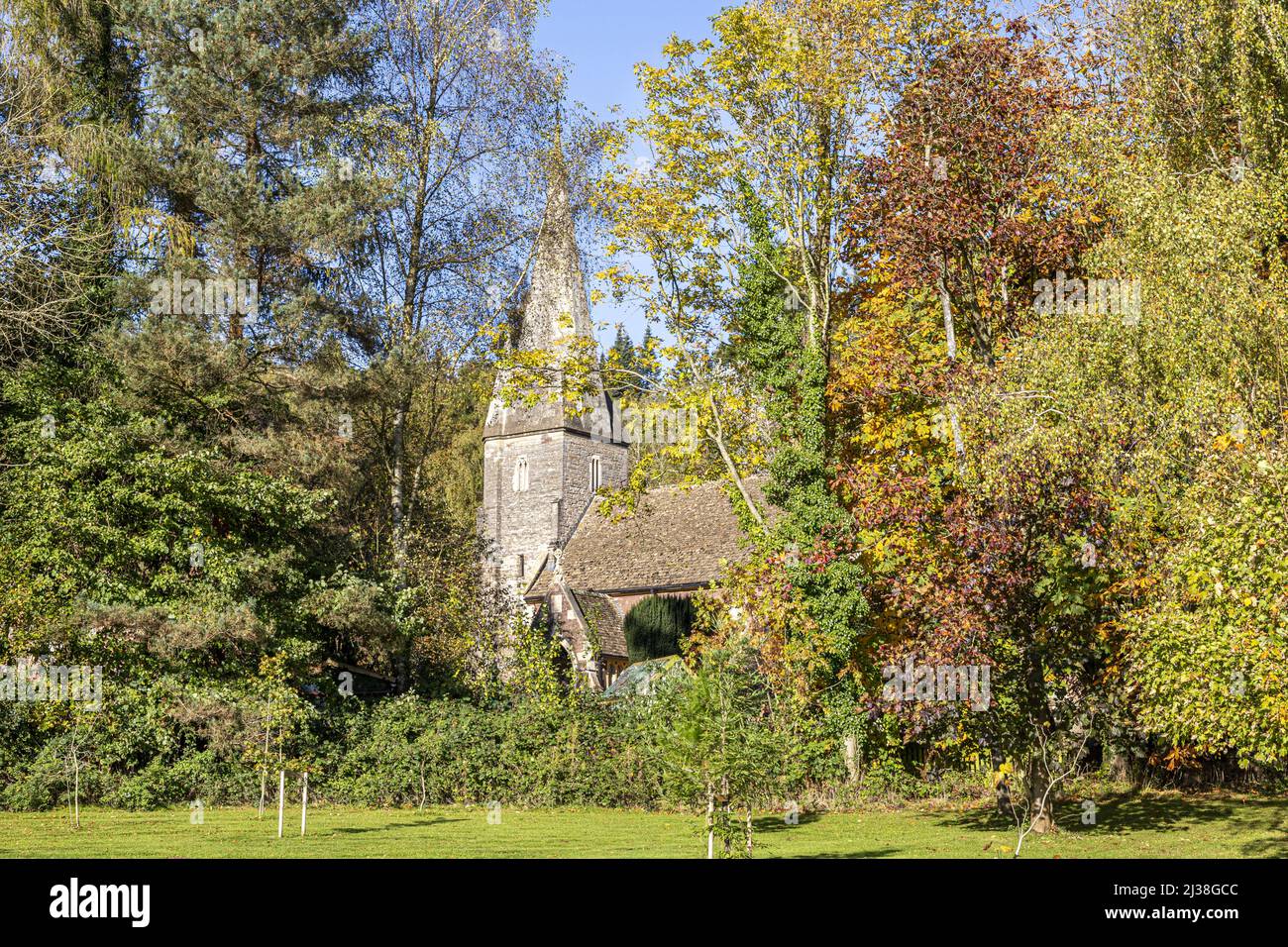 Autumn colours at the church of St John the Baptist in the Forest of Dean village of Huntley, Gloucestershire, England UK Stock Photo