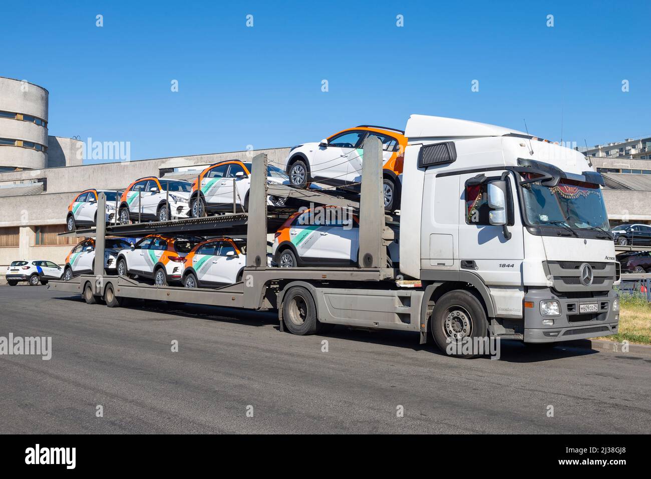 SAINT PETERSBURG, RUSSIA - JULY 17, 2021: A car carrier with new cars of the Delimobil carsharing company close-up. Saint-Petersburg Stock Photo