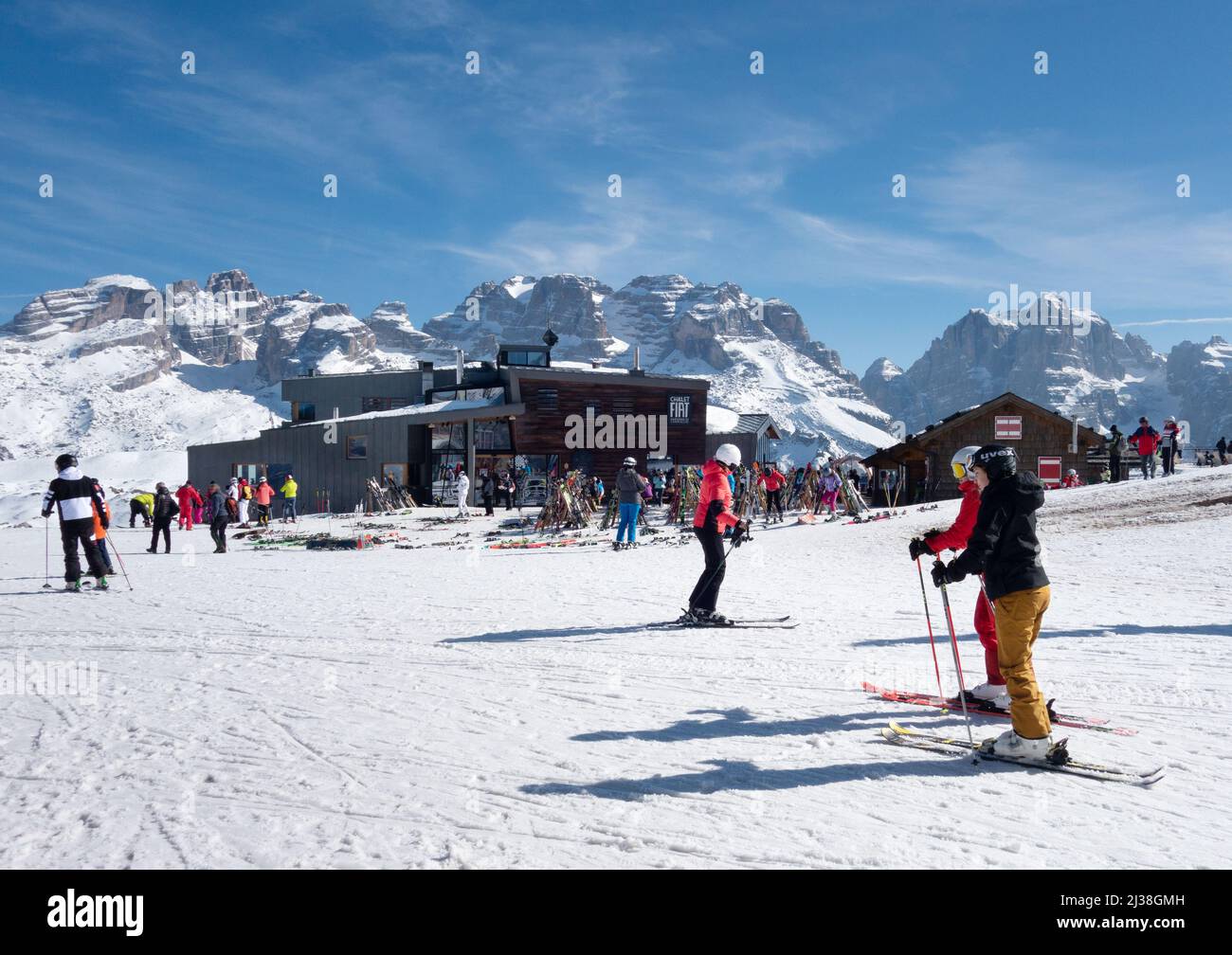 Ski Holiday; Skiers approaching the Chalet Fiat Restaurant on the ski slopes on a skiing holiday, Madonna do Campiglio, Dolomites Italy Europe Stock Photo