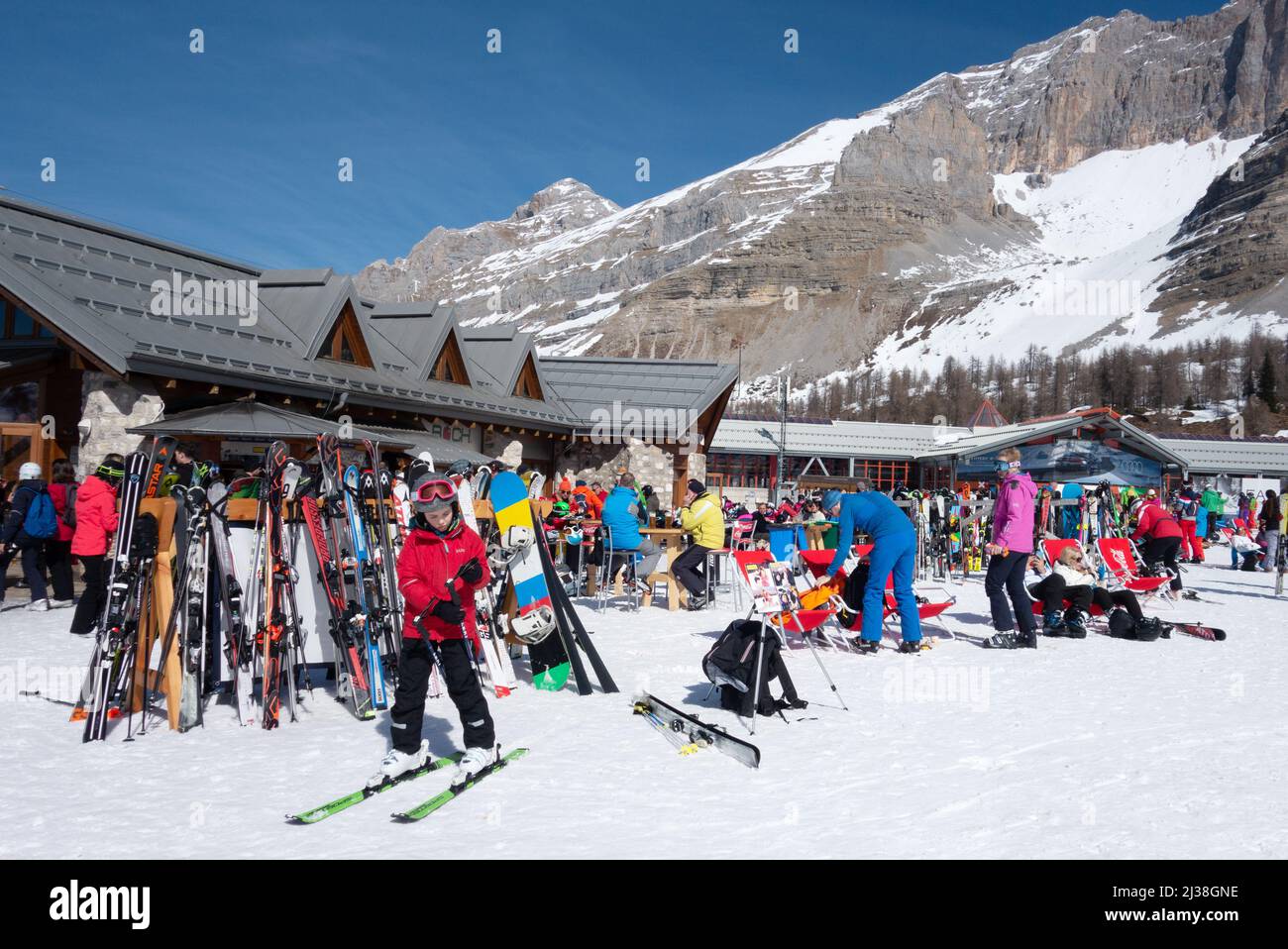Children skiing at the Boch Cafe on the ski slopes for lunch, on a ski holiday, Madonna di Campiglio Dolomites Italy Europe Stock Photo