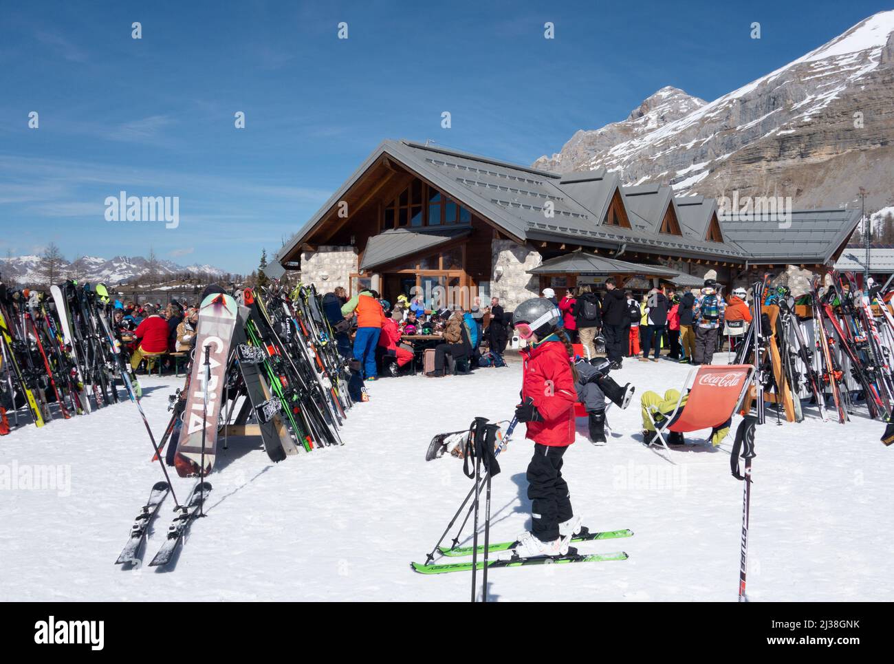 Child skiing at the Boch Cafe on the ski slopes for lunch, on a ski holiday, Madonna di Campiglio Dolomites Italy Europe Stock Photo
