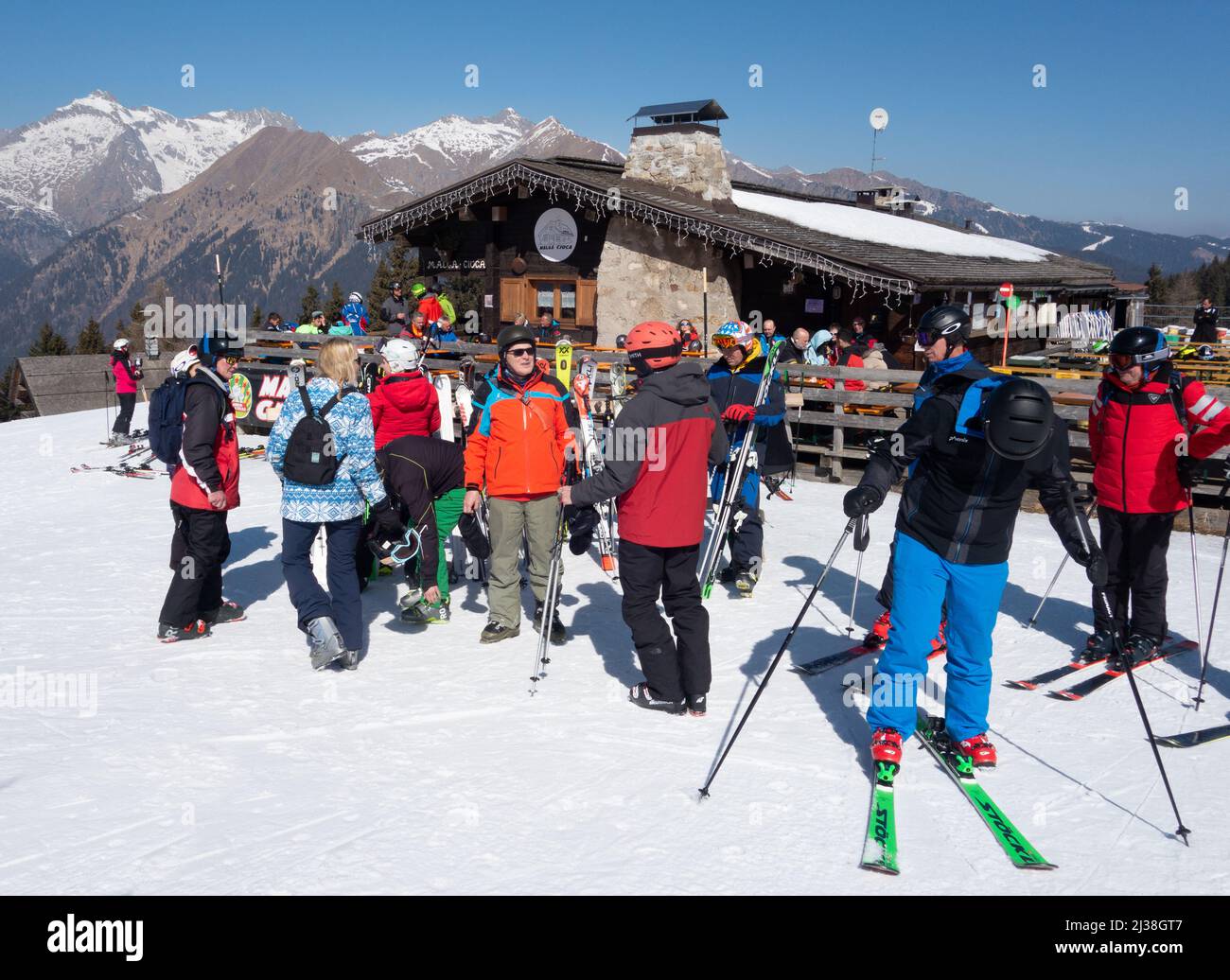 Italy Ski holiday scene - skiers skiing to the Malga Croca mountain restaurant and bar for food and drink, Pinzolo Dolomites Italy Europe Stock Photo