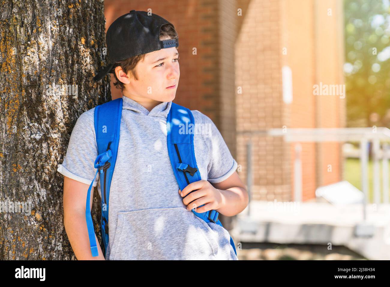 Young children boy on the school playground with backpack Stock Photo
