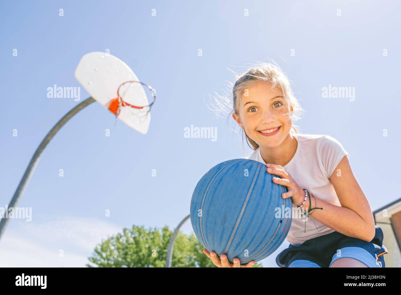 Girl holding a basketball at the park Stock Photo - Alamy