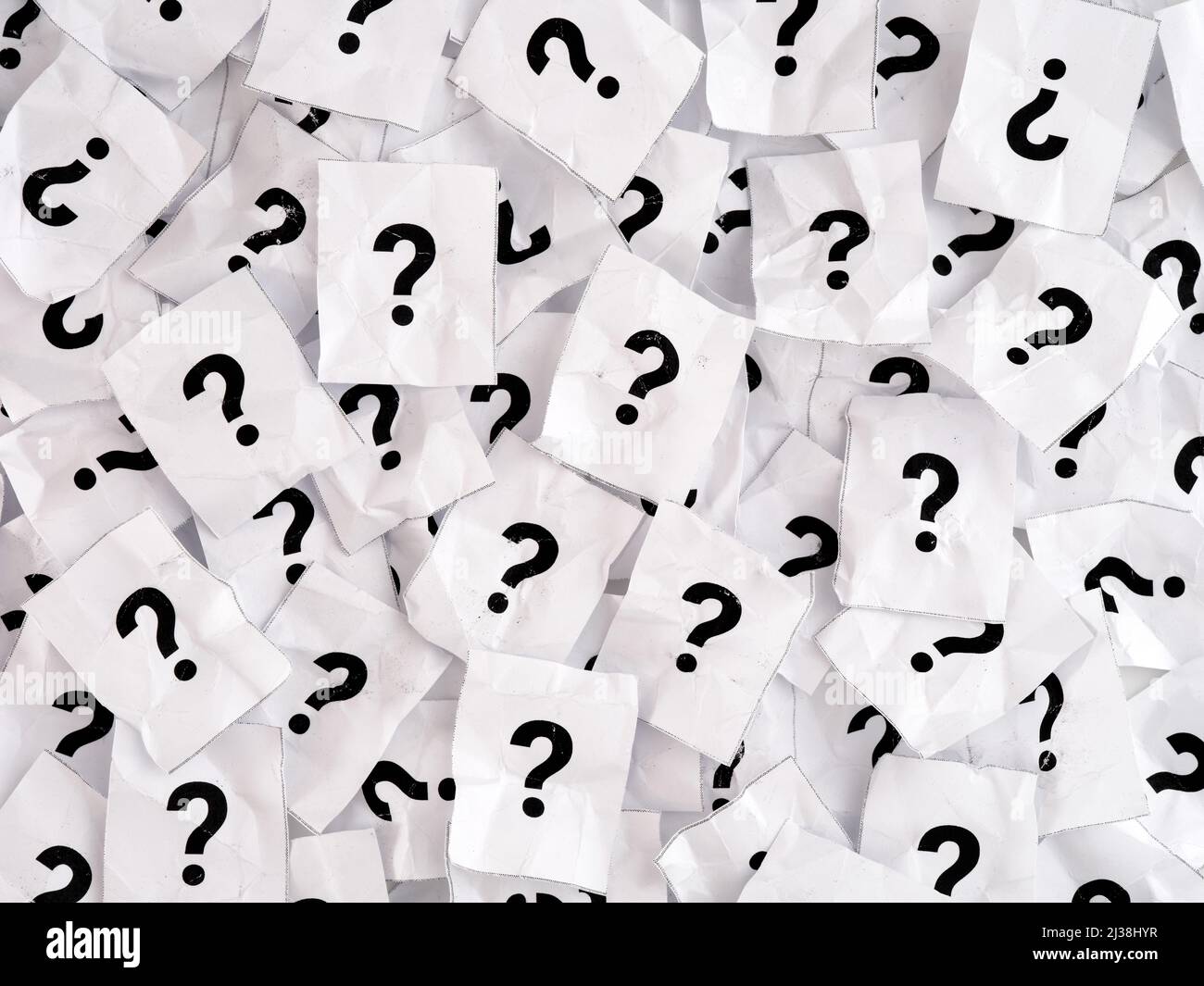 A lot of crumpled paper notes with question marks. Black and White. Full frame Stock Photo