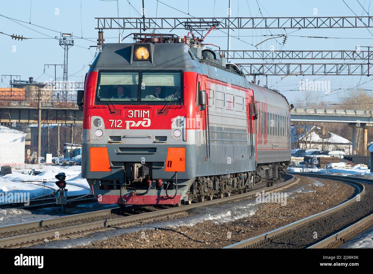 SHARYA, RUSSIA - MARCH 18, 2022: Russian modern electric locomotive EP1M-712 with a passenger train on the Sharya station of the Northern Railway Stock Photo