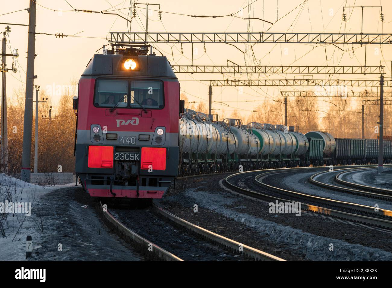 SHARYA, RUSSIA - MARCH 19, 2022: Electric locomotive 2ES5K 'Ermak' with a freight train in a turn on the March evening. Northern Railway Stock Photo