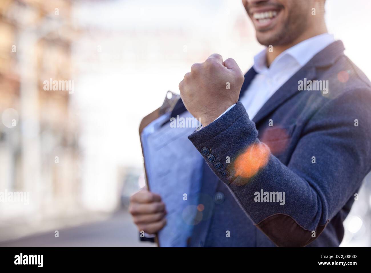 Celebrating my career success. Shot of a businessman cheering in excitement while holding a clipboard. Stock Photo