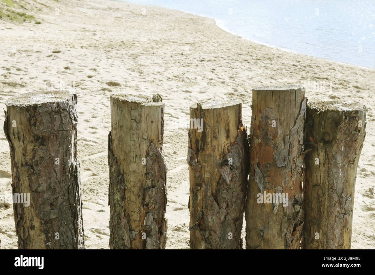 A wooden palisade, sheltered from the wind, on a sandy beach by the sea. Tourists destination Stock Photo