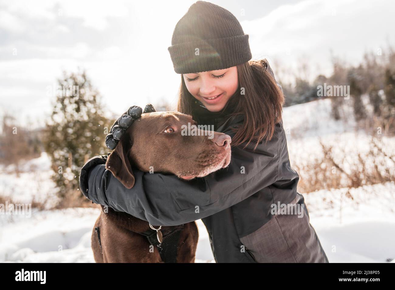 Portrait of little girl with labrador dog in winter season Stock Photo