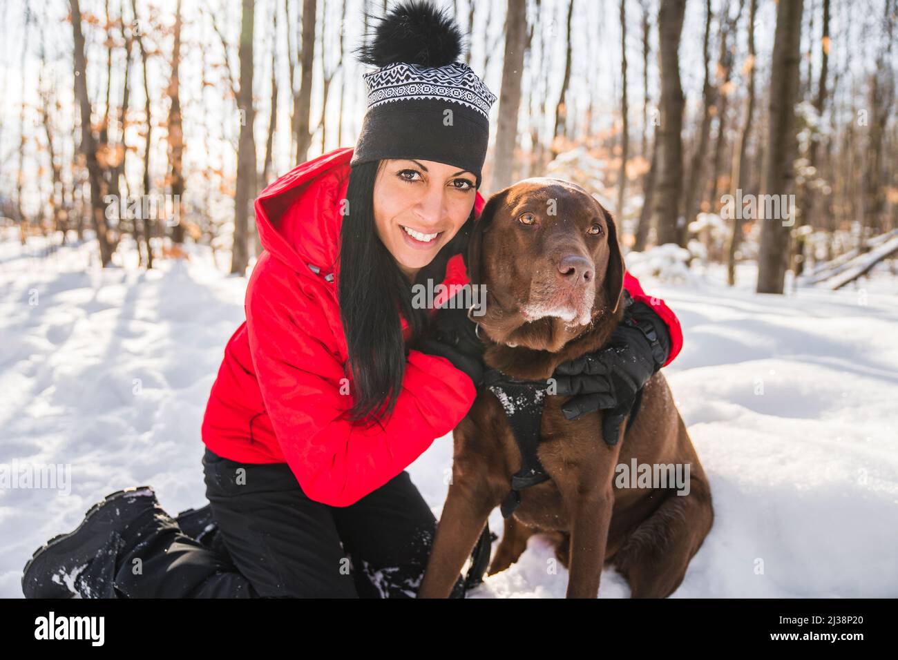 Portrait of a woman with labrador dog in winter season Stock Photo