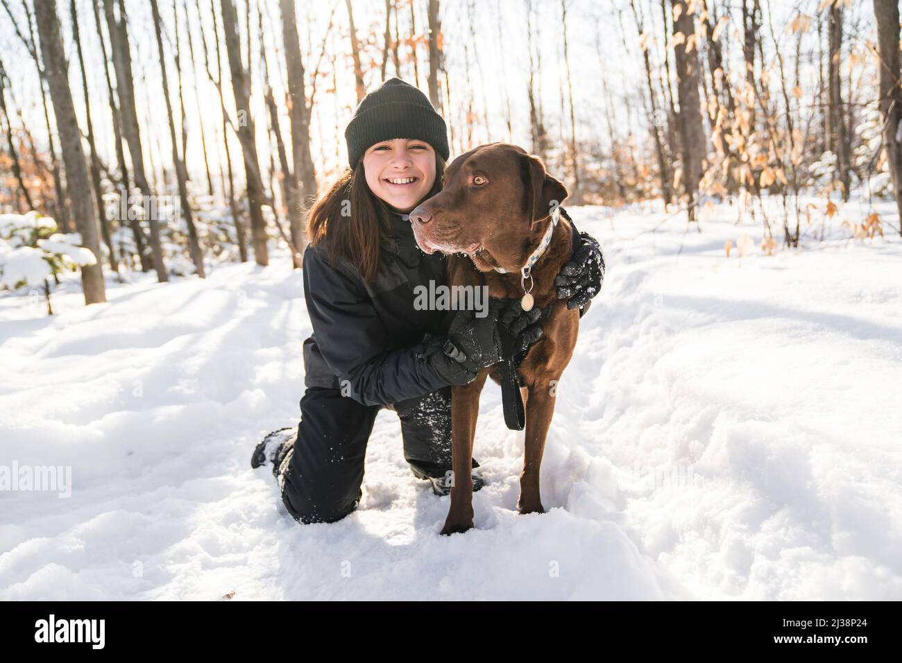 Portrait of little girl with labrador dog in winter season Stock Photo