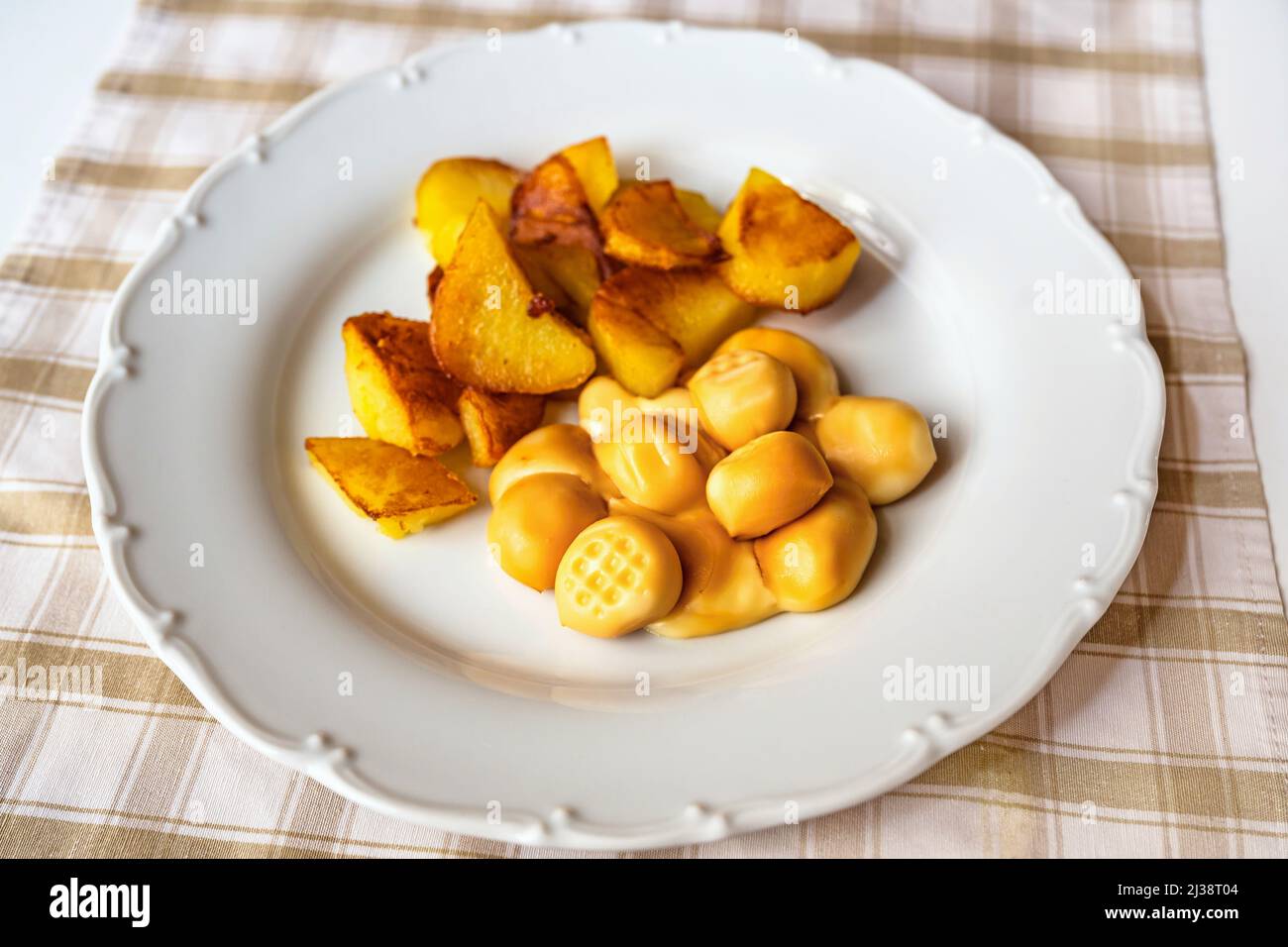 Smoked cheese balls with fried potato on plate on table,closeup. Stock Photo
