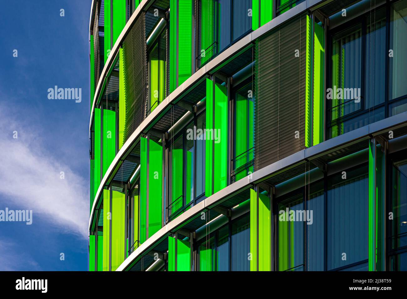 A front shot of a modern building with yellow and green walls next to