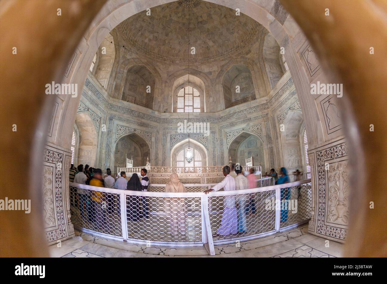 AGRA, INDIA - NOV 15, 2011: people visit the inside of the mausoleum Taj Mahal in India, the worlds famous grave. Stock Photo