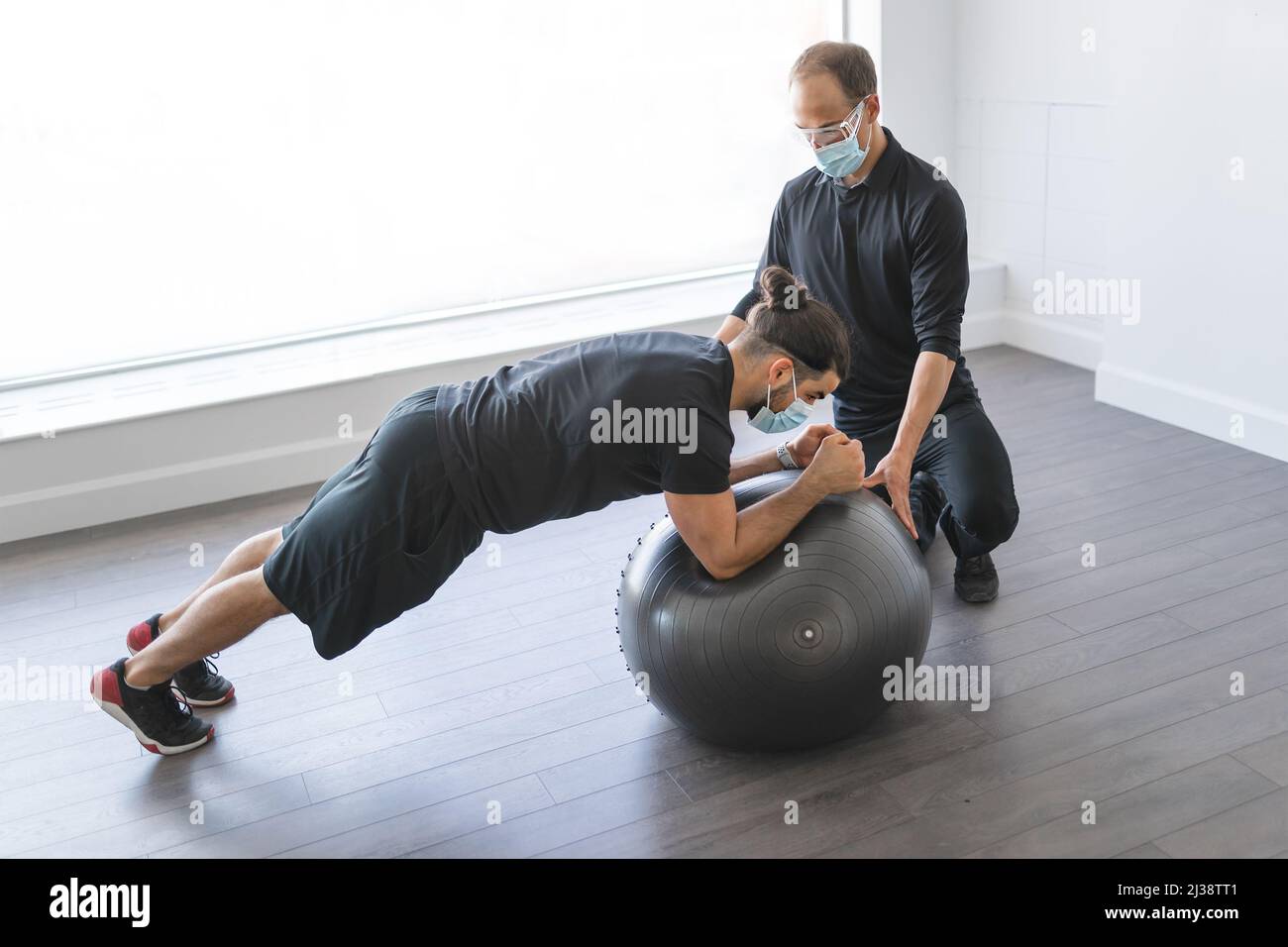 Patient Exercise physiotherapist doing therapeutic exercises for patient at the clinic ...